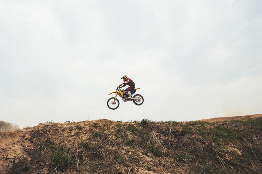 Jumping in air motorcyclist on  motocross motorcycle at the training ground