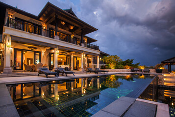 Luxury Rich large two-storey villa with open-air pool, interior evening photo - obrazy, fototapety, plakaty