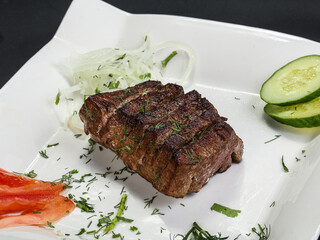 Grilled beef steak served onion