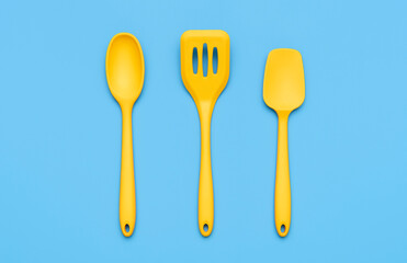 Yellow kitchenware set isolated on blue background above view.