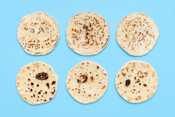 Indian bread above view on blue table. Homemade naan bread
