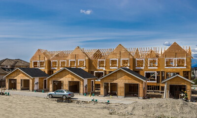 Construction of a new wooden building in a residential area of Richmond City. Construction of the house at the stage of the foundation laid and the beginning of the framing works on the walls