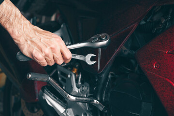 Fototapeta premium mechanic fixing a motorcycle in the garage