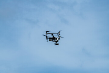 drone in flight at work against the blue sky