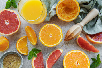 Glass of juice and citrus fruits.