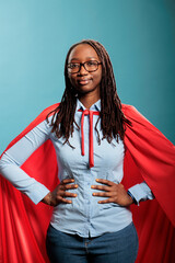 Joyful happy smiling young adult person posing as justice defender on blue background. Proud...