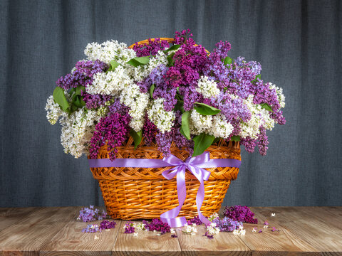 spring bouquet. lilacs in a basket on the table. rural still life