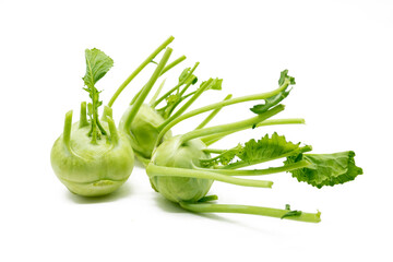 Fresh kohlrabi with green leaves on isolated white background