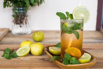 herbal healthy drinks lemon tea for health care arrangement on background wooden