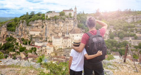 children and father looking at Rocamadour city view