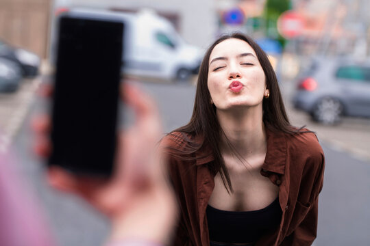 influence by taking and uploading video of girl sending a kiss to the network live on the street