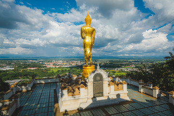Fototapeta na wymiar The Golden Buddha statue at Wat Phra That Khao Noi, or Phrathat Khao Noi temple, is the top attraction with a fantastic view of Nan province, Thailand