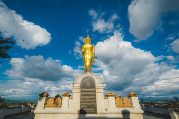 Fototapeta na wymiar The Golden Buddha statue at Wat Phra That Khao Noi, or Phrathat Khao Noi temple, is the top attraction with a fantastic view of Nan province, Thailand