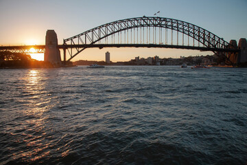 Fototapeta na wymiar Large bridge across the bay at sunset on the water, Harbour Bridge, Sydney, Australia