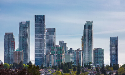 Fototapeta premium New residential area of high-rise buildings in the city of Burnaby, in the center of the city against the blue sky, Vancouver Canada