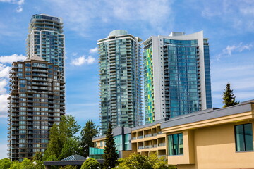 Obraz na płótnie Canvas New residential area of high-rise buildings in the city of Burnaby, in the center of the city against the blue sky, Vancouver Canada