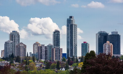 Obraz premium New residential area of high-rise buildings in the city of Burnaby, in the center of the city against the blue sky, Vancouver Canada