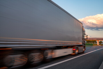Truck on highway during spectacular sunset,Intentional motion blur