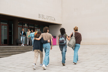 Anonymous friends walking in campus before studies