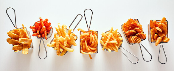 Various French fries on table
