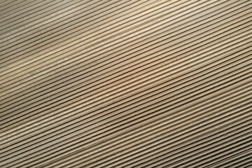 Aerial view of a plowed field ready for sowing as background.