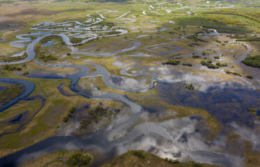Aerial view of winding flooded river beds with ducts, during the spring flood.