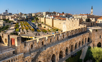 Obraz na płótnie Canvas Walls of Tower Of David citadel and Old City over Jaffa Gate and Hativat Yerushalayim street with Mamilla quarter of Jerusalem in Israel