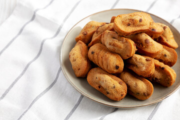 Homemade Chocolate Chips Madeleines on a Plate, low angle view. Space for text.