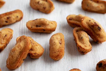 Homemade Chocolate Chips Madeleines on a white wooden background, side view.