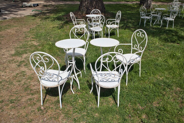 Outdoor restaurant background, metal white chairs and tables