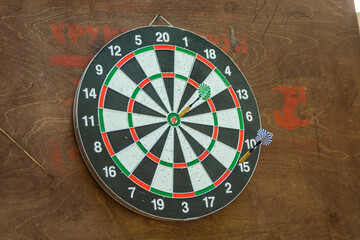 Darts board with dart on target