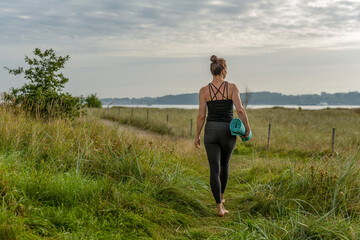 woman doing yoga at the beach