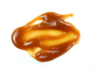 Sweet caramel sauce isolated on white background close up. Golden Butterscotch toffee caramel liquid. Melted caramel sauce drop.