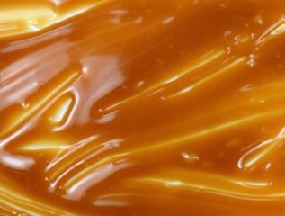 Sweet caramel sauce drop background close up. Golden Butterscotch toffee caramel liquid. 