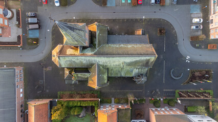 Fototapeta na wymiar Rijkevorsel, Belgium, 28 January 2022. Sint Jozef Rijkevorsel old street and a view of Saint Joseph's Church from above. Aerial drone view. High quality photo