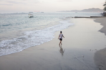 Woman walking and enjoying empty paradise tropical beach. Nobody around.