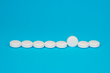 White pills antibiotic round on blue background