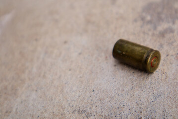 Crime evidence concept.Bullet gun on ground.