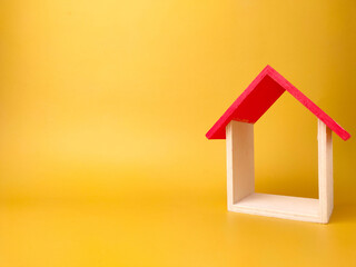 Obraz na płótnie Canvas Toy house isolated on yellow background with copy space