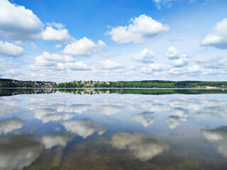 Beautiful cloudy sky reflecting on calm lake