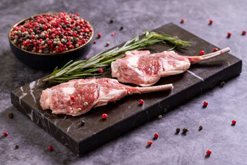 Lamb chops on dark background. Raw lamb chops with spices. close up