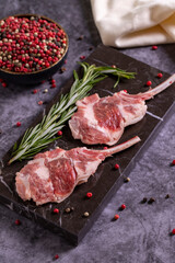 Lamb chops on dark background. Raw lamb chops with spices. close up
