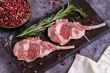Lamb chops on dark background. Raw lamb chops with spices. close up