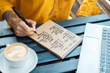 Young woman writing in notebook self-care ideas list for the mind, soul, body