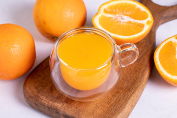 Fototapeta na wymiar Freshly squeezed orange juice on a white background. Fresh orange juice. close up