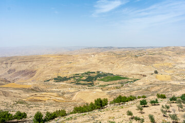 Fototapeta na wymiar Muonth Nebo, Jordan - June 5 2019: Spectacular view of the Jordanian landscape from Mount Nebo