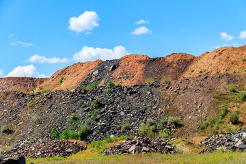 Fototapeta na wymiar View of slag heaps of iron ore quarry. Mining industry
