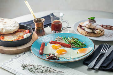 Middle Eastern Breakfast, Fried Eggs, Sauseges, Toast on Served Table