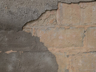 Texture of a stone wall with traces of cement and paint