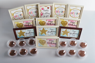 Happy birthday celebration card on frames and gifts displayed on the table